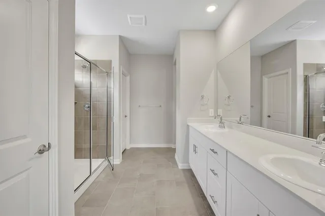 a spacious bathroom with a double vanity sink mirror and double