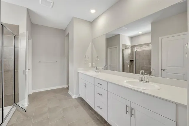 a bathroom with double sink and a mirror
