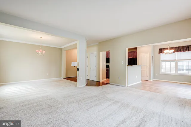 a view of wooden floor and a chandelier in a kitchen