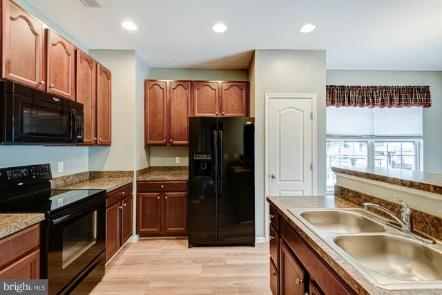 a view of a big room with windows and a chandelier fan