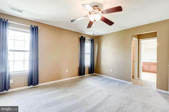a spacious bathroom with a bathtub sink and mirror