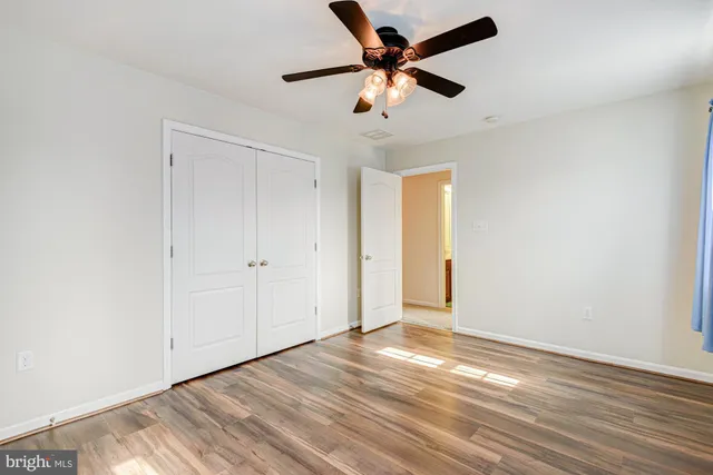 a view of a livingroom with wooden floor and a flat screen tv