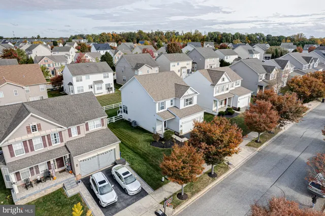 an aerial view of residential houses with outdoor space and swimming pool
