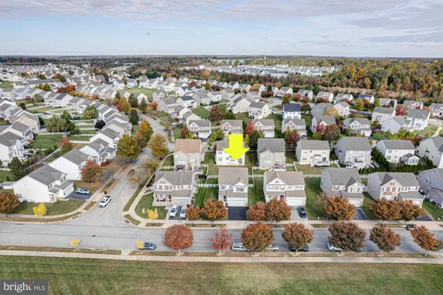 an aerial view of residential houses with outdoor space and swimming pool