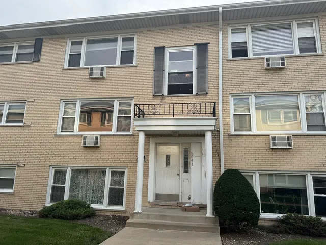 a view of a brick building with many windows