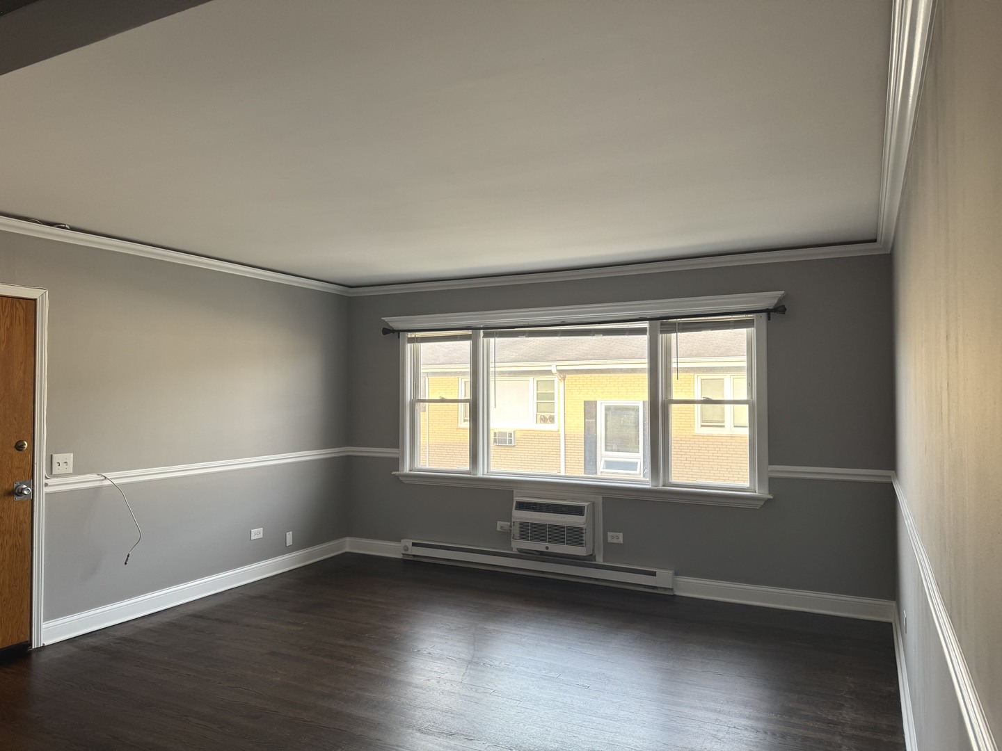 5041 North East River Road, Unit 3A Norridge, IL 60706 - Photo 3 of 12 a view of an empty room with wooden floor and a window
