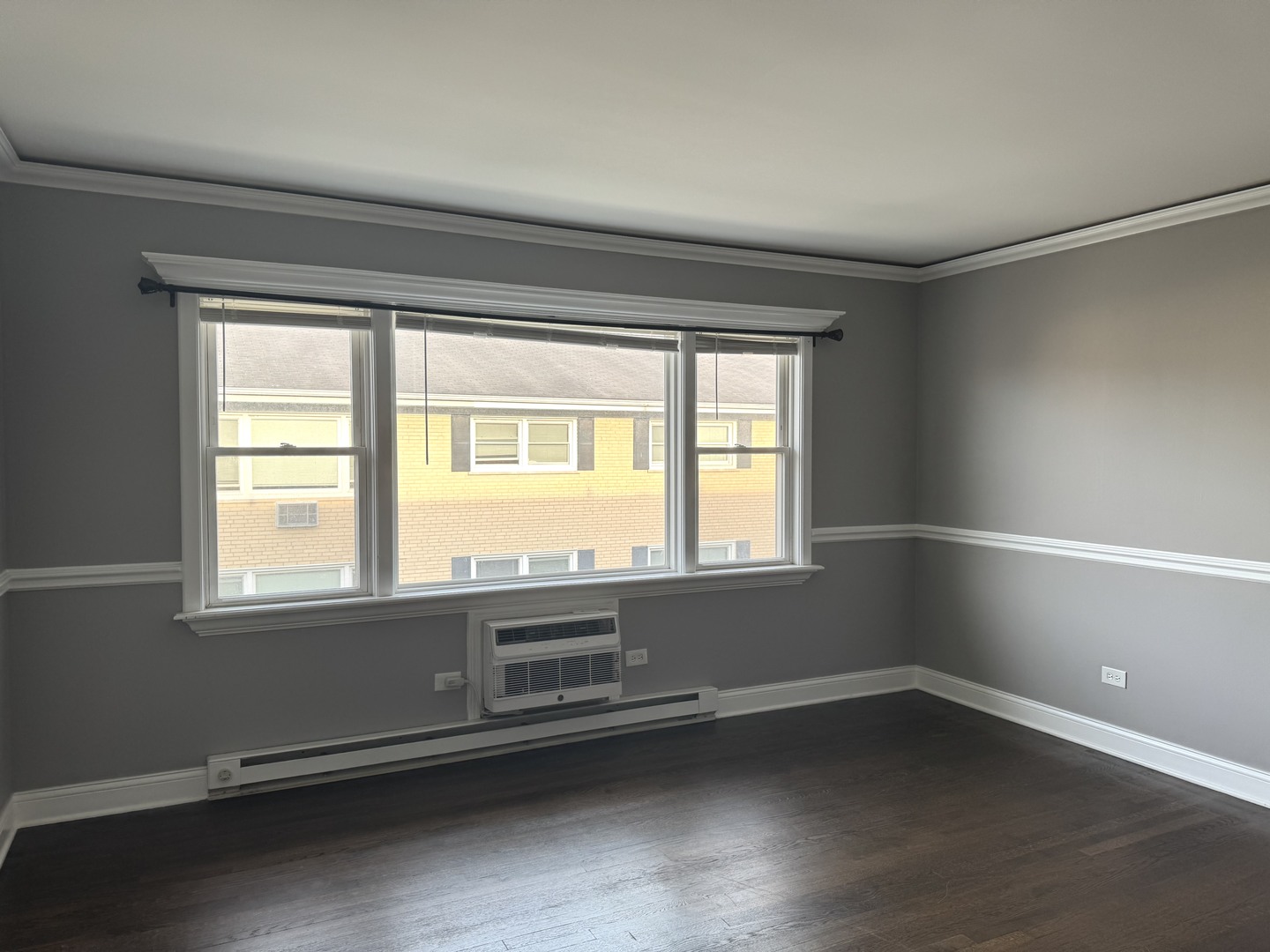 5041 North East River Road, Unit 3A Norridge, IL 60706 - Photo 5 of 12 an empty room with wooden floor and windows