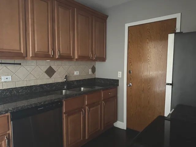 a kitchen with a sink and a refrigerator