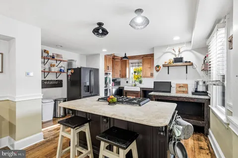 a view of a dining room with furniture and a kitchen