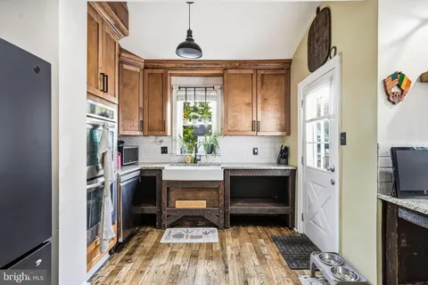 a kitchen with cabinets and window
