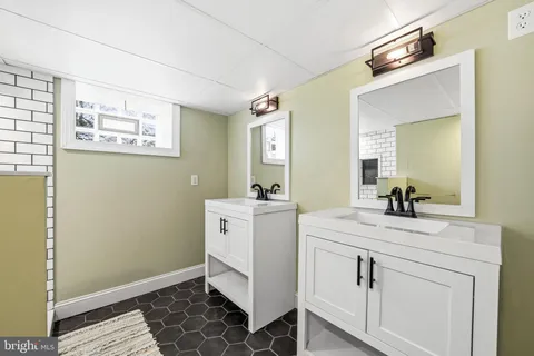 a room with a sink and a mirror