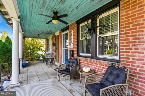 a balcony with furniture and a potted plant