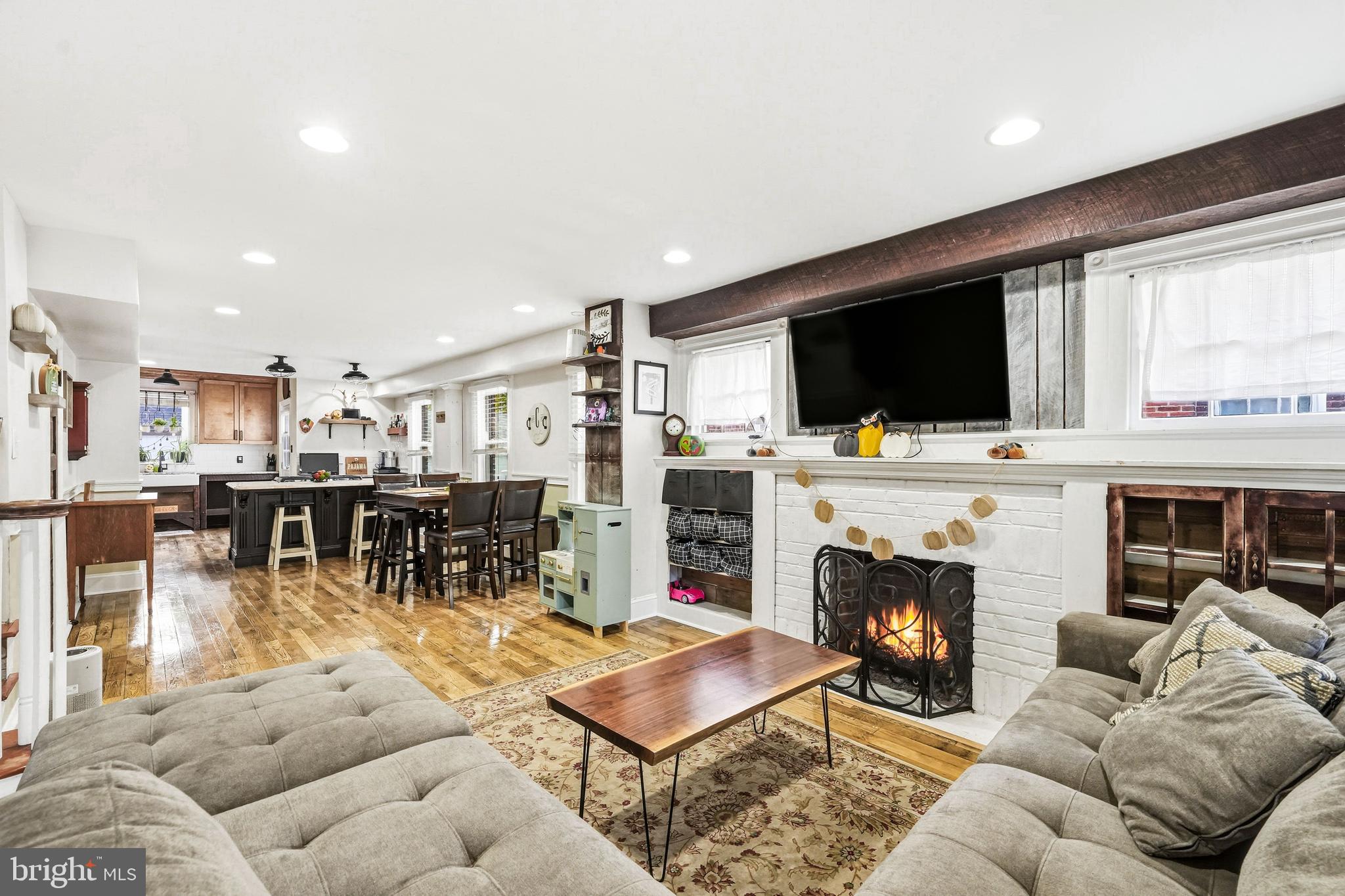 8129 Hennig Street Philadelphia, PA 19111 - Photo 7 of 31 a living room with furniture a flat screen tv and a fireplace