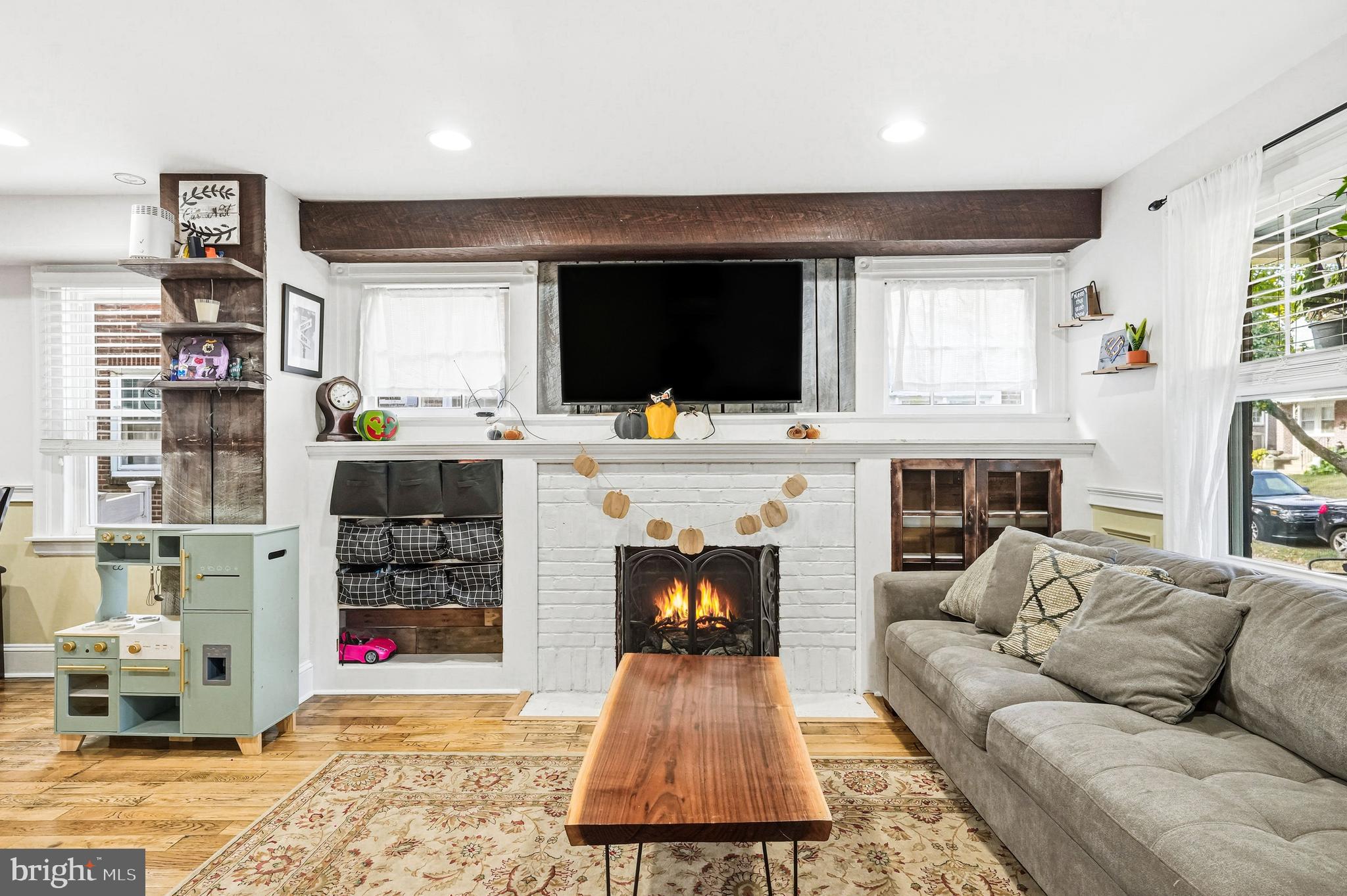8129 Hennig Street Philadelphia, PA 19111 - Photo 9 of 31 a living room with furniture a flat screen tv and a fireplace