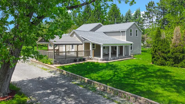 a view of a house with a yard and sitting area