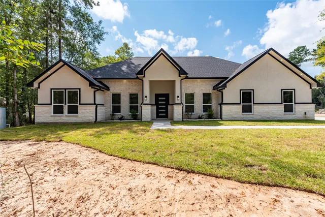 a view of a house with a swimming pool and a yard