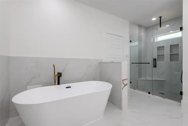 a white bath tub sitting in a bathroom