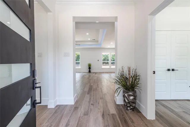 a view of a hallway and wooden floor and dining room