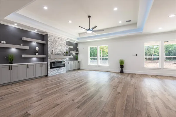 a kitchen with kitchen island granite countertop a sink a center island stainless steel appliances and cabinets