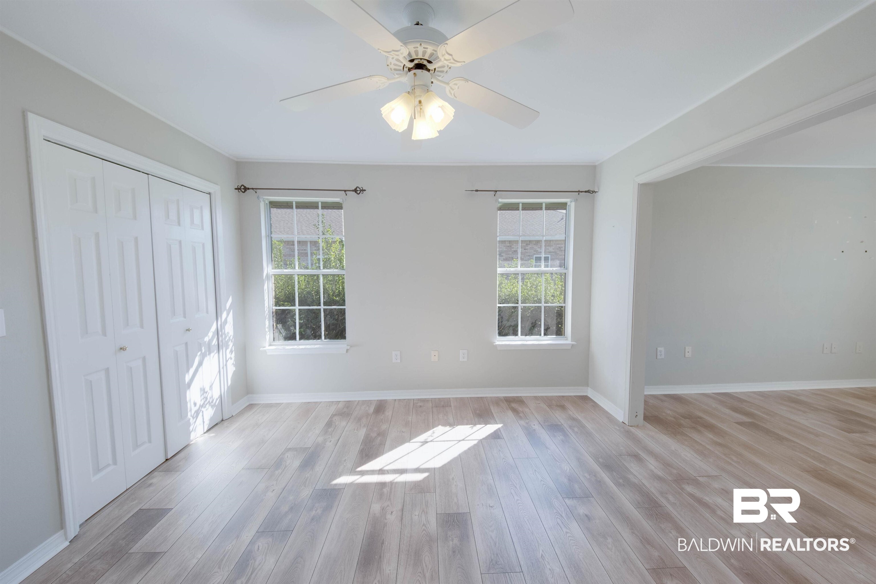 9462 Lakeview Drive Foley, AL 36535 - Photo 39 of 50 Empty room featuring ceiling fan, a healthy amount of sunlight, and light wood-type flooring