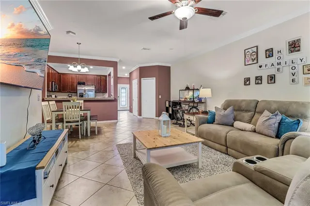 a living room with furniture and a chandelier