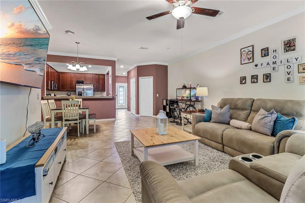 2722 Citrus Street Naples, FL 34120 - Photo 11 of 35 a living room with furniture and a chandelier