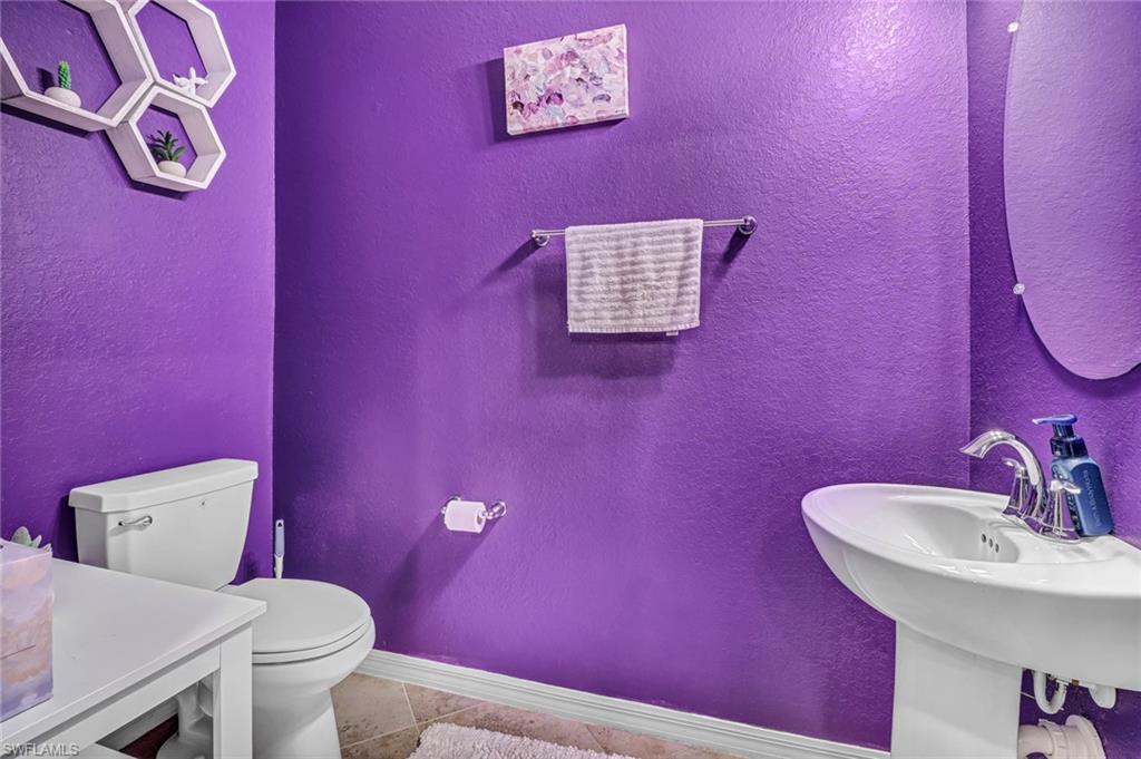 2722 Citrus Street Naples, FL 34120 - Photo 14 of 35 a bathroom with a sink a toilet and mirror