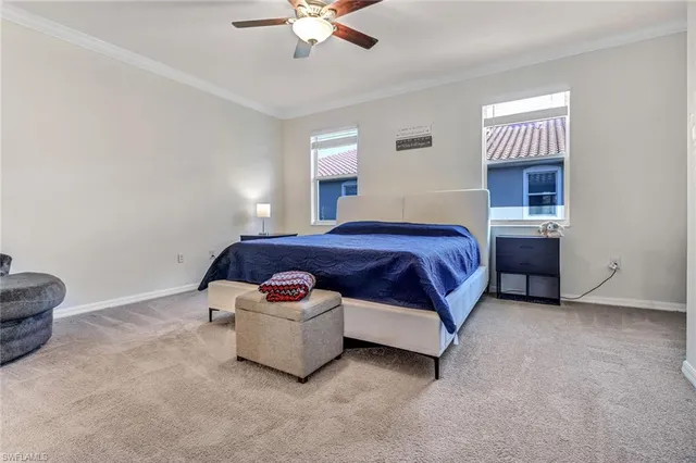 a bedroom with a bed and a ceiling fan