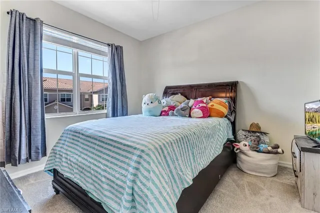 a bedroom with bed and window