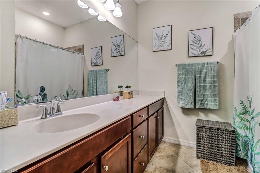 2722 Citrus Street Naples, FL 34120 - Photo 20 of 35 a bathroom with a sink and a mirror