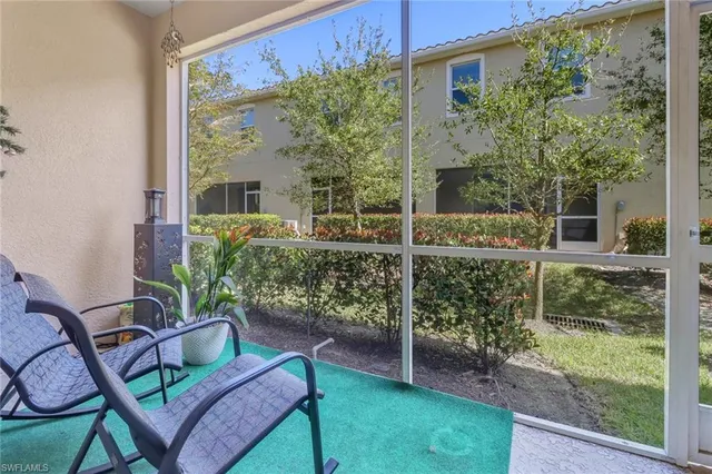 a view of a porch with chairs and backyard