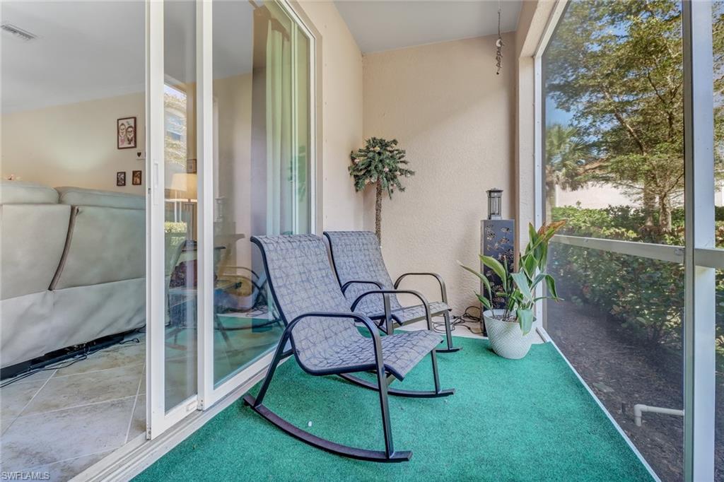 2722 Citrus Street Naples, FL 34120 - Photo 24 of 35 a view of a balcony with chairs and a table