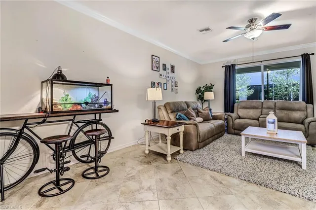 a living room with furniture a flat screen tv and a window