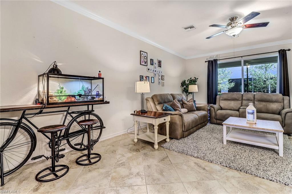 2722 Citrus Street Naples, FL 34120 - Photo 9 of 35 a living room with furniture a flat screen tv and a window