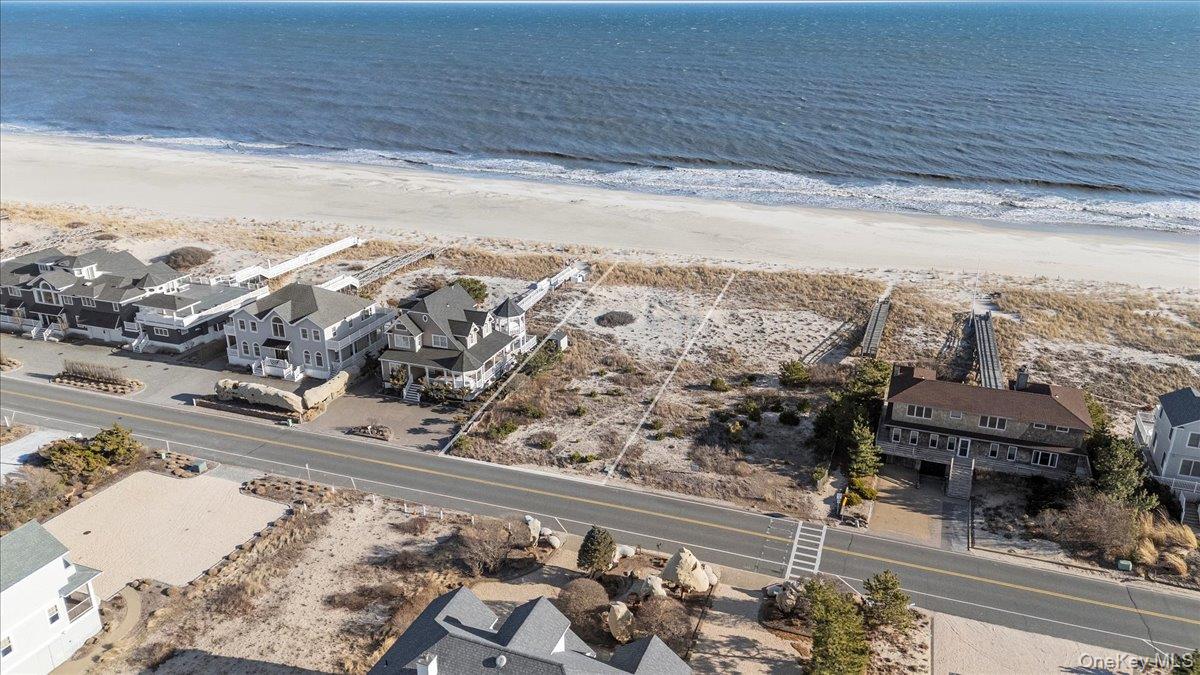 699 Dune Road Westhampton Beach, NY 11978 - Photo 1 of 9 a view of a terrace with wooden floor and a ocean view