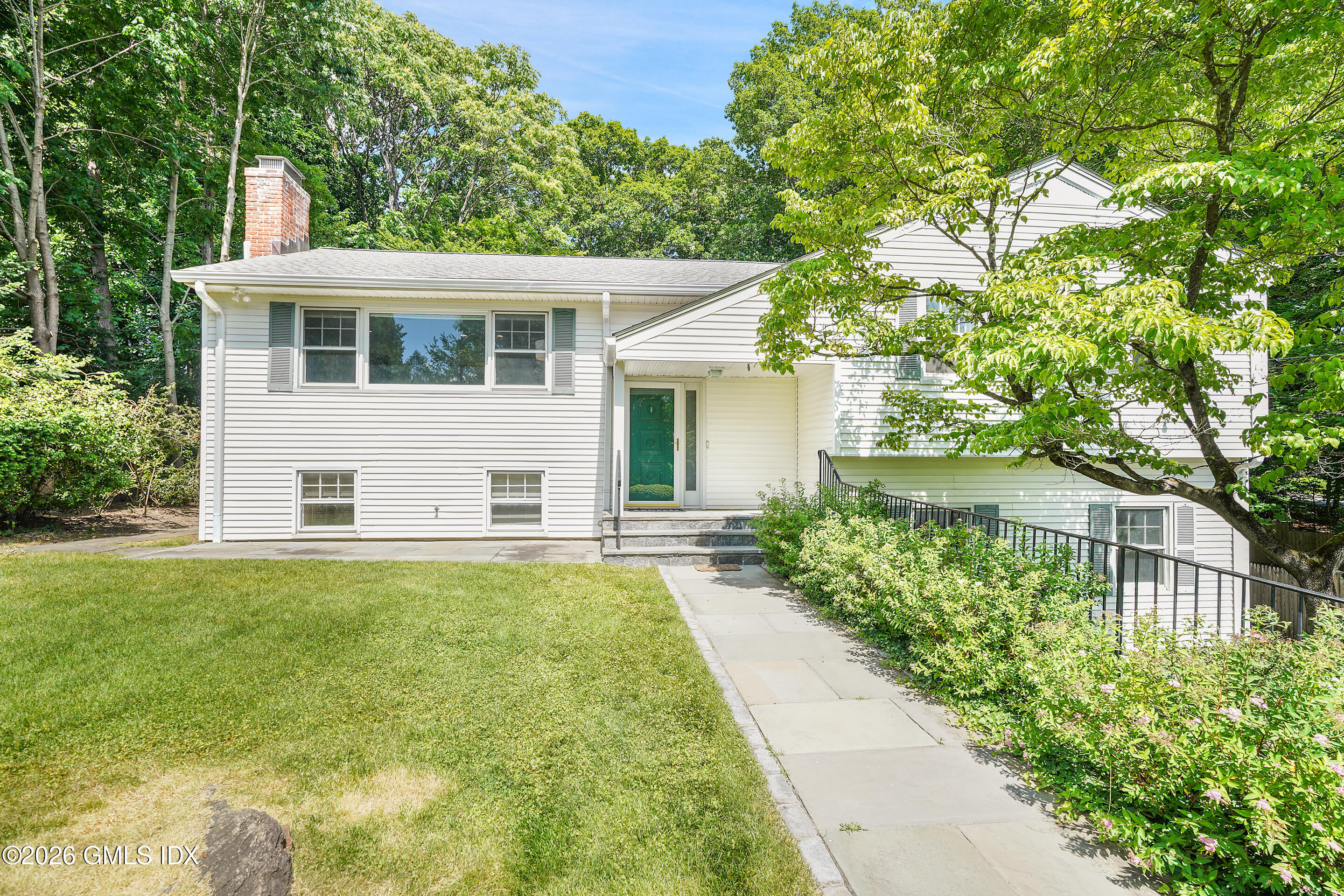 33 Sachem Road Greenwich, CT 06830 - Photo 32 of 35 front view of a house with a yard