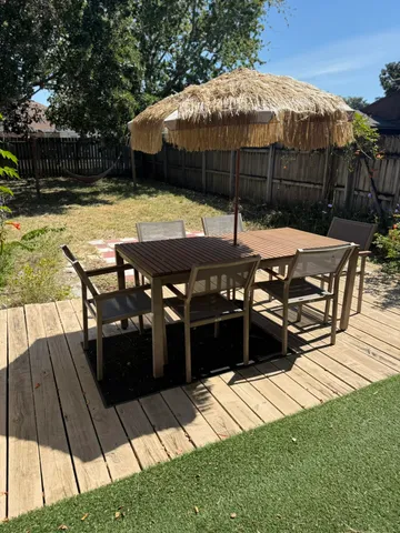 a view of house with backyard patio and swimming pool