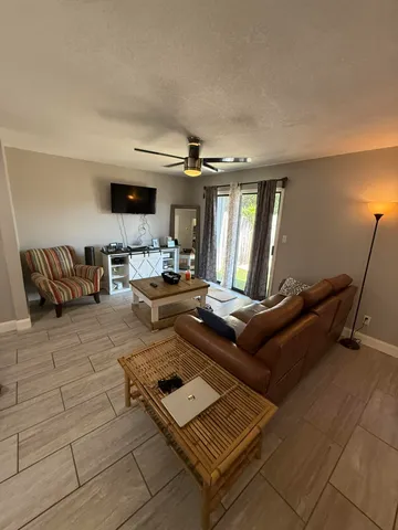 a living room with furniture rug and window