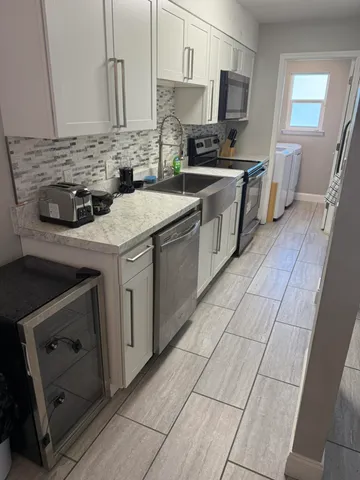 a kitchen with a sink stove and cabinets