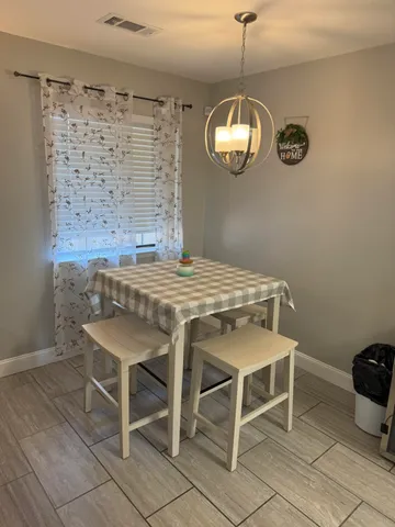 a view of a dining room with furniture and chandelier