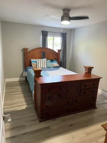a bed sitting in a bedroom and wooden floor