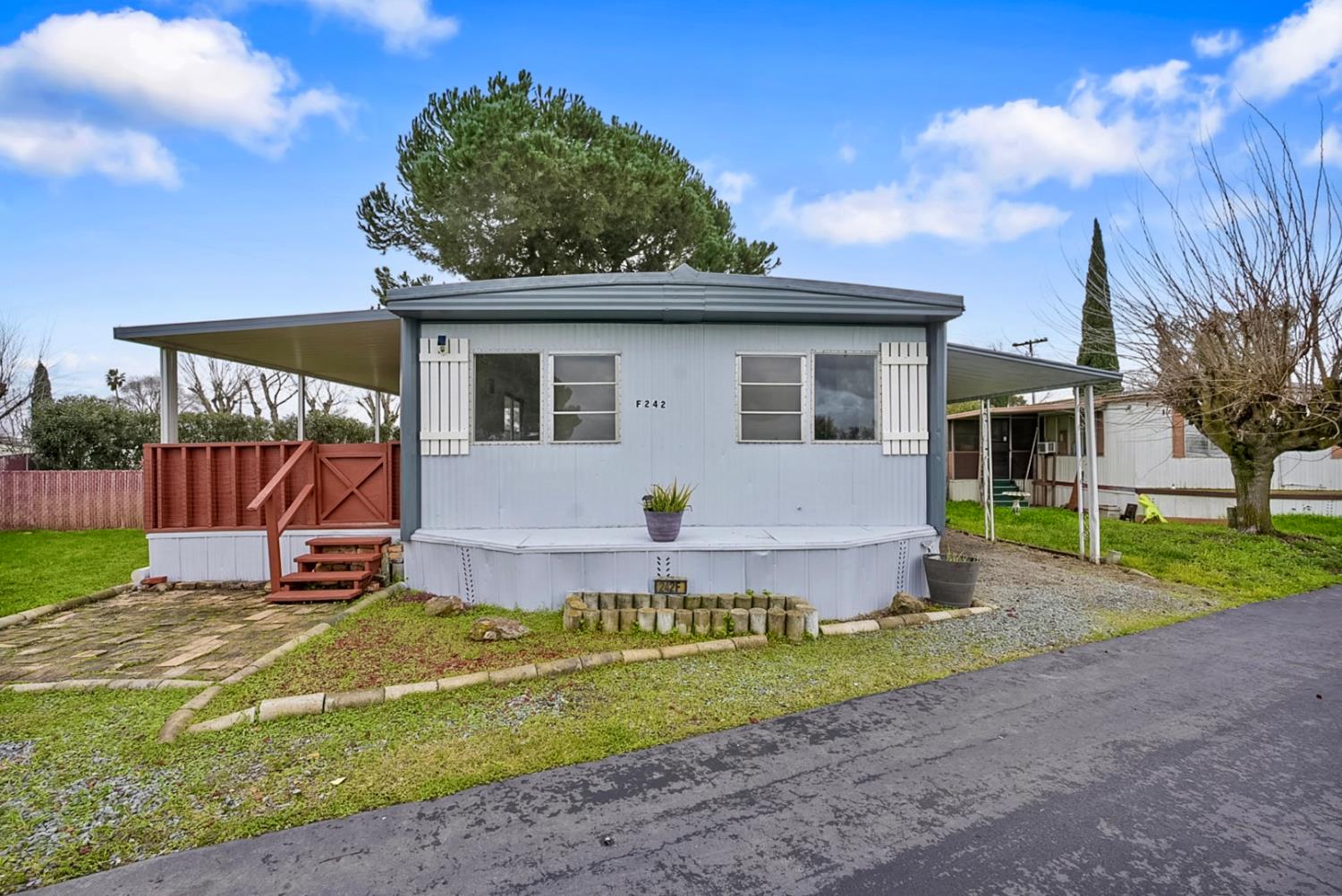 3505 Gateway Road, Unit F242 Bethel Island, CA 94511 - Photo 2 of 22 a view of a house with backyard and a tree
