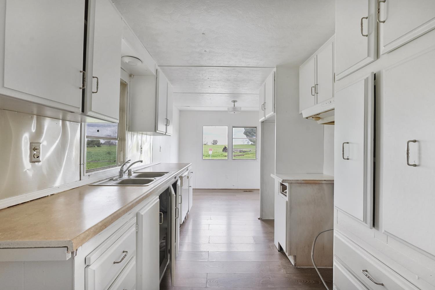 3505 Gateway Road, Unit F242 Bethel Island, CA 94511 - Photo 5 of 22 a kitchen with stainless steel appliances granite countertop a refrigerator and a sink