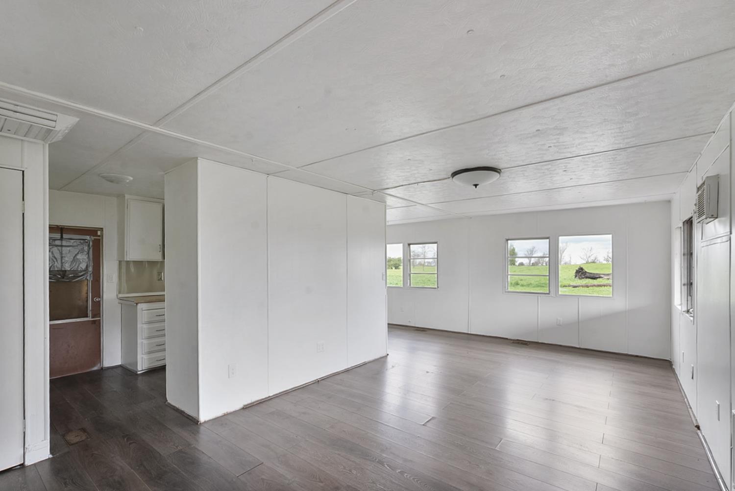 3505 Gateway Road, Unit F242 Bethel Island, CA 94511 - Photo 6 of 22 an empty room with wooden floor and windows