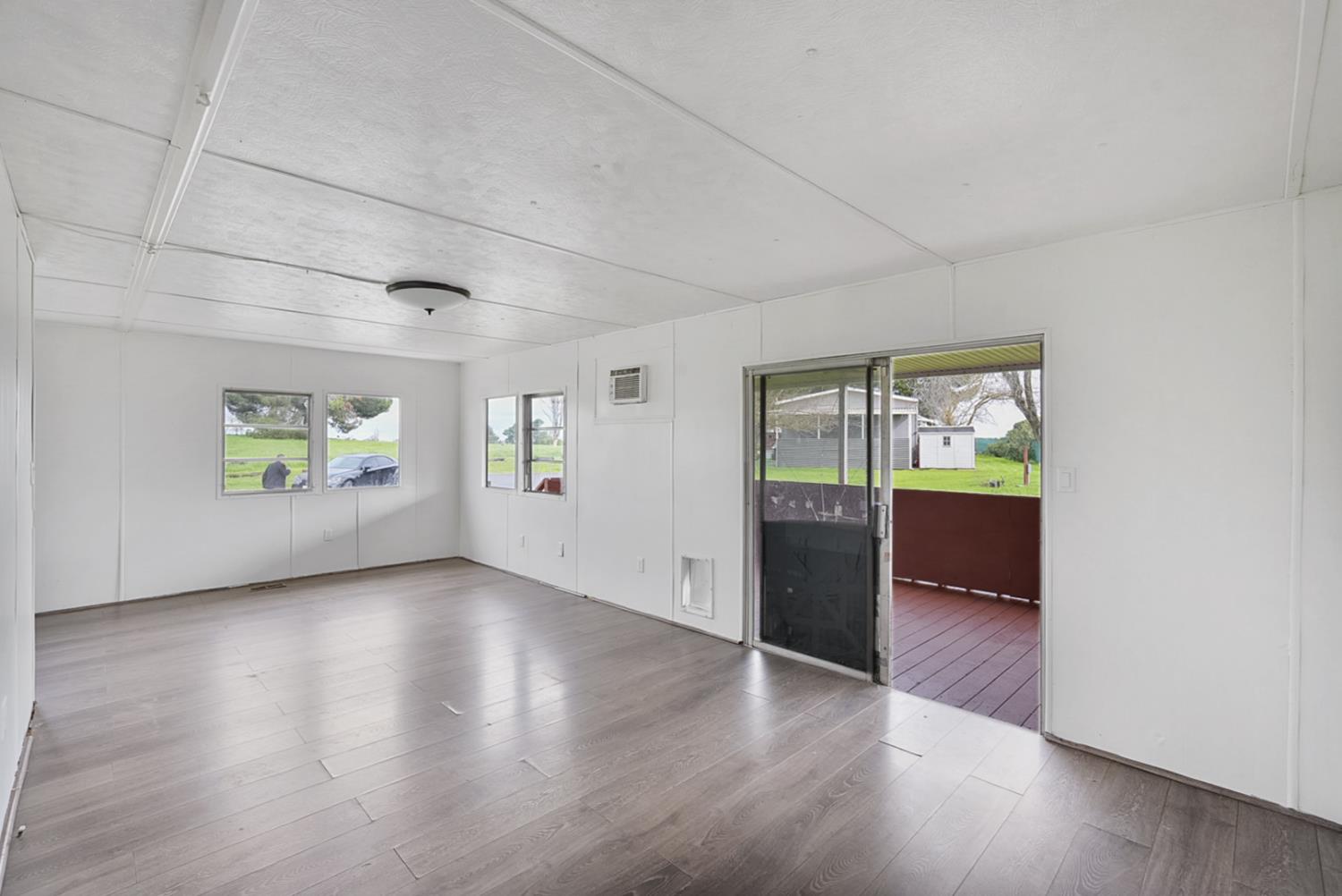 3505 Gateway Road, Unit F242 Bethel Island, CA 94511 - Photo 7 of 22 an empty room with wooden floor and windows