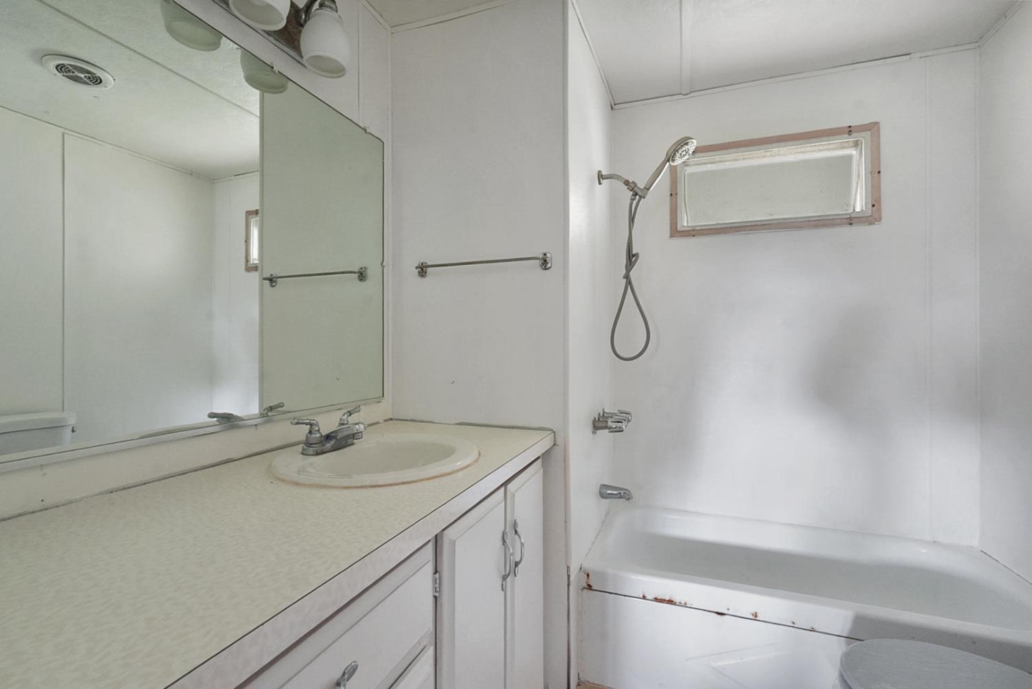3505 Gateway Road, Unit F242 Bethel Island, CA 94511 - Photo 8 of 22 a bathroom with a granite countertop sink and a mirror