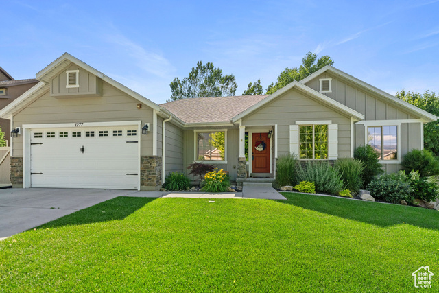 1277 Quail Run Lane Elk Ridge, UT 84651 - Photo 1 of 1 View of front of property with a garage and a front yard
