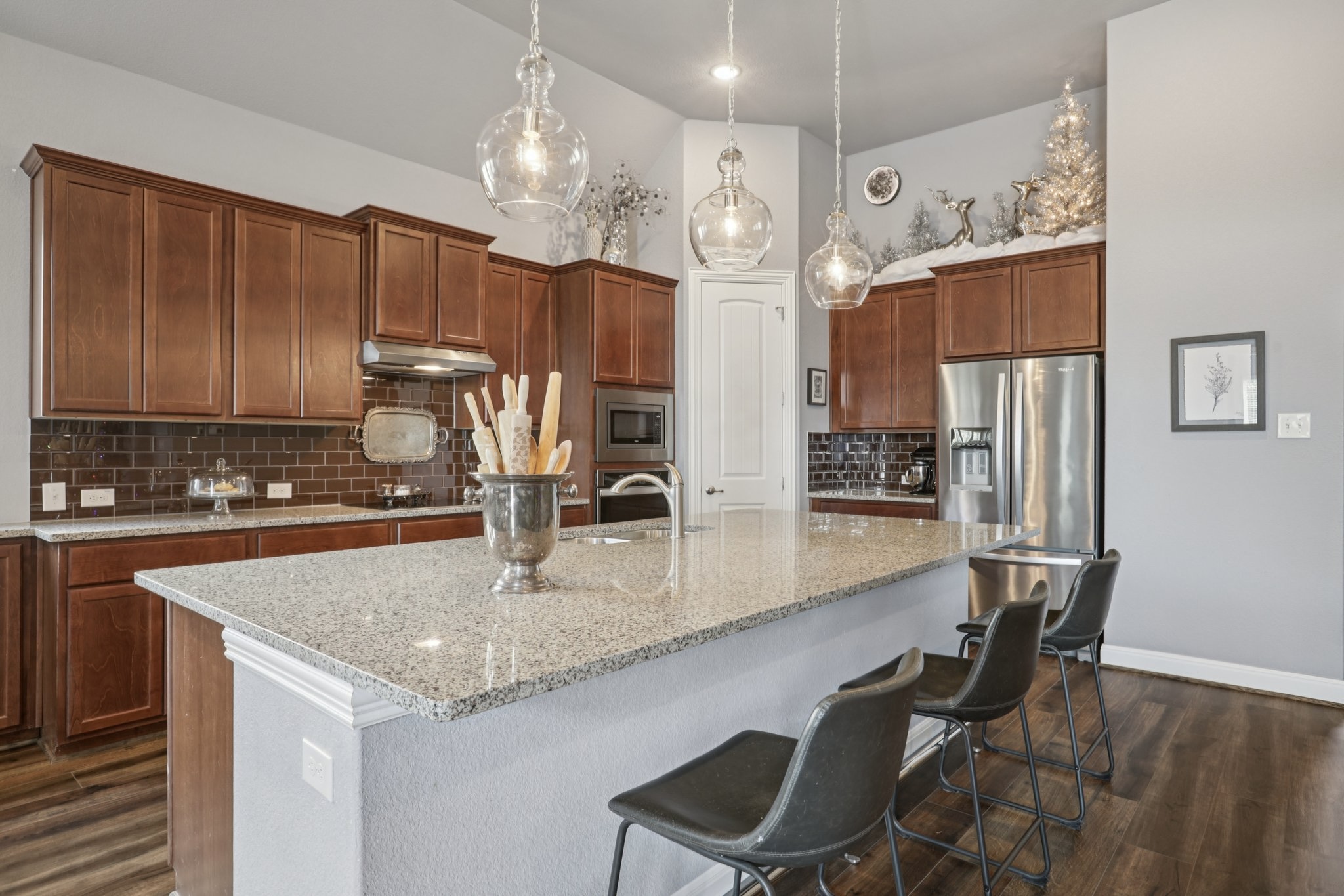 210 Barton Run Drive Georgetown, TX 78628 - Photo 14 of 40 a kitchen with stainless steel appliances granite countertop a sink refrigerator and cabinets