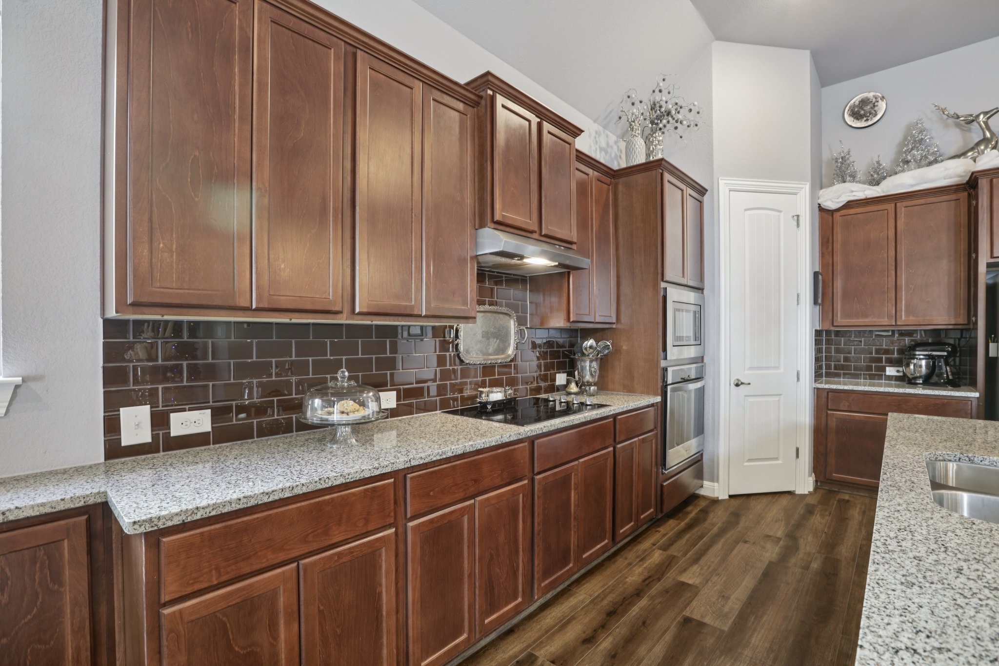 210 Barton Run Drive Georgetown, TX 78628 - Photo 16 of 40 a kitchen with wooden cabinets and white appliances
