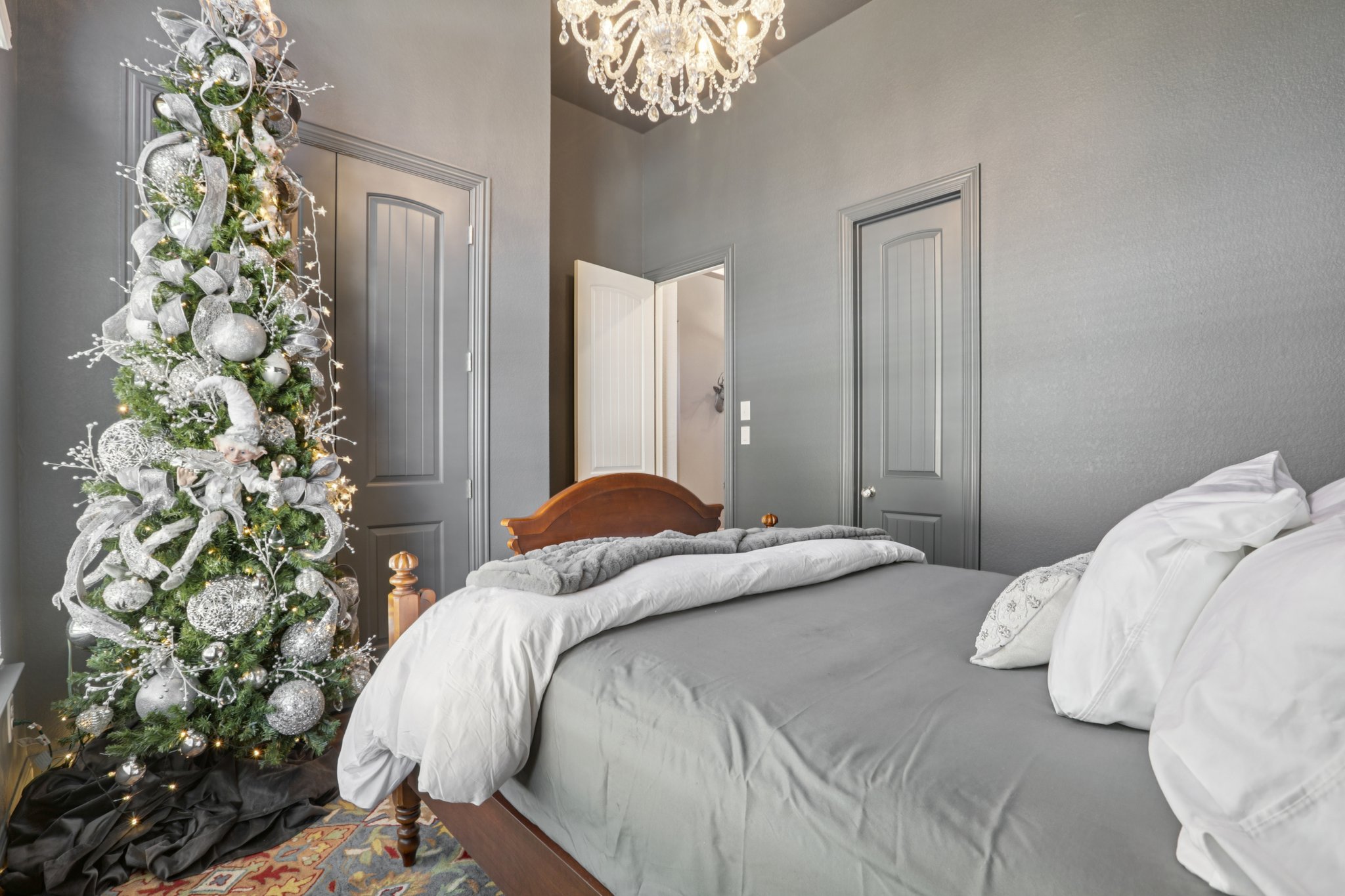 210 Barton Run Drive Georgetown, TX 78628 - Photo 19 of 40 a bedroom with a bed and a chandelier